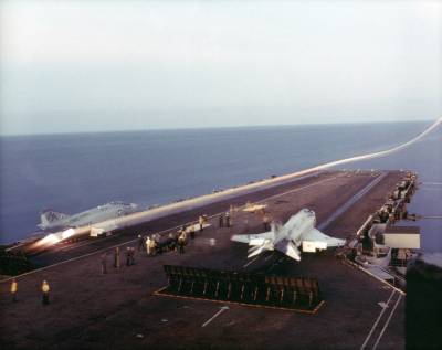 На снимке показан старт с борта авианосца «Форрестол» (CVA-59) палубного F4H «Фантом» из эскадрильи Red Rippers, 1973 год. След форсажного факела обозначил траекторию взлета самолета с незначительной просадкой.
