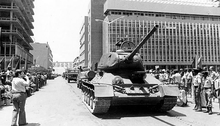 Сормовский Т-34-85 на параде в Анголе. Машина прошла модернизацию, о чем можно судить по ИК-осветителю ФГ-100 на правом борту корпуса. Луанда, 9 февраля 1976 года.