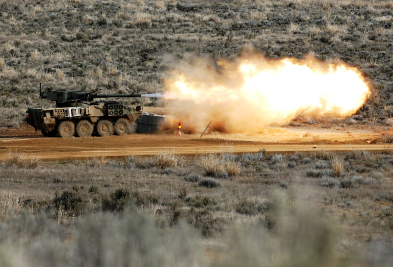 M1128 Stryker MGS ведет огонь. Да, вам не показалось: на борту в районе МТО находится внешний блок системы кондиционирования. Изначально кондиционера внутри не было, но позже конструкторы сжалились над экипажами