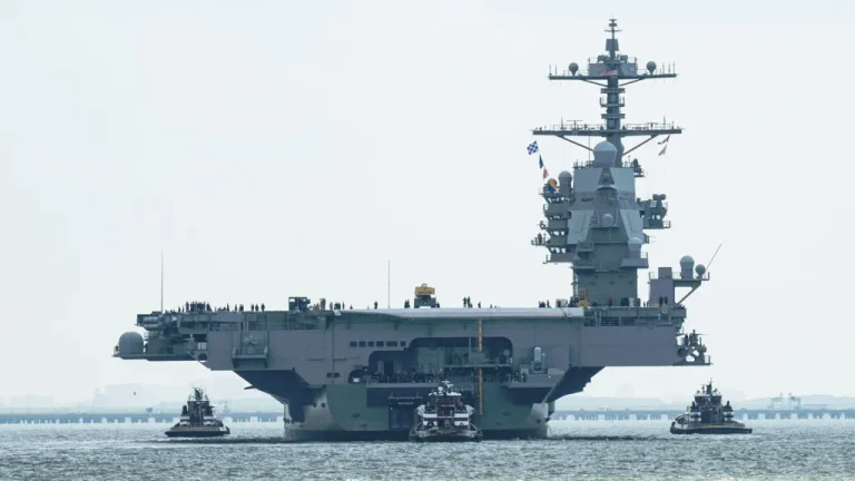 Будущий USS «John F. Kennedy» покидает порт для начала приемочных морских испытаний 12 августа 2026 года. Осветитель радара Mk 95 виден на спонсоне на левом борту в кормовой части корабля. HII
